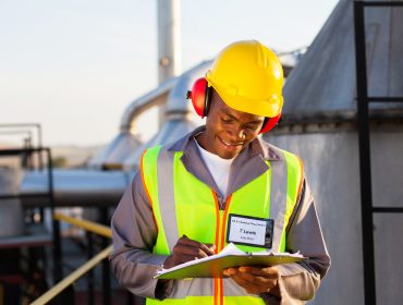 happy african american oil chemical industry worker working in plant